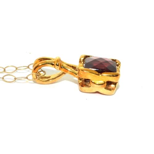 294 - 9ct gold checker cut Garnet pendant necklace on a 44cm gold chain 