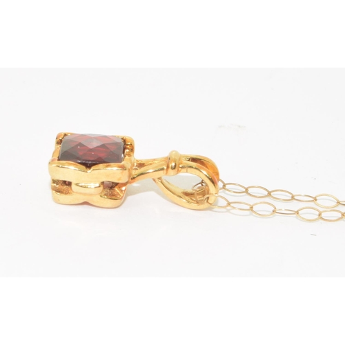 294 - 9ct gold checker cut Garnet pendant necklace on a 44cm gold chain 