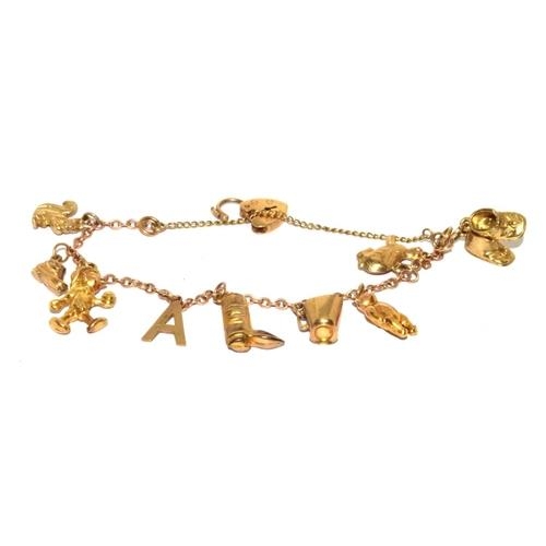 314 - 9ct gold charm bracelet with heart padlock and safety chain together with 8 charms 10.5g