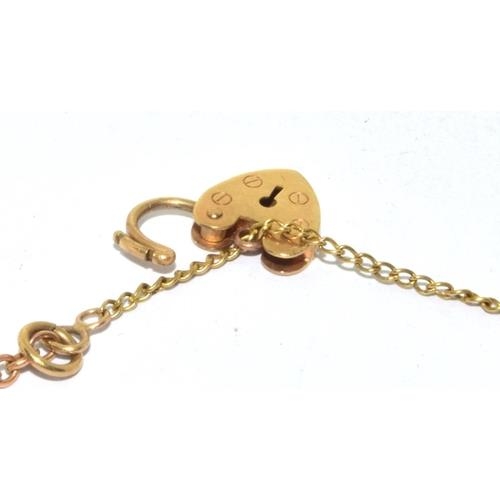 314 - 9ct gold charm bracelet with heart padlock and safety chain together with 8 charms 10.5g