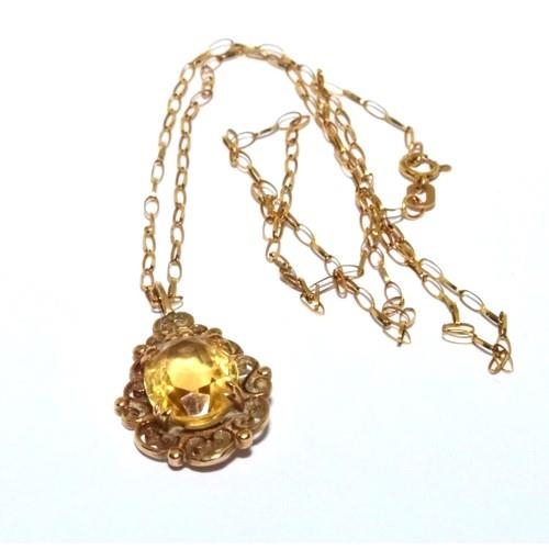 344 - 9ct gold Citrine pendant necklace in a scroll open work design on a 46cm chain