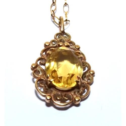 344 - 9ct gold Citrine pendant necklace in a scroll open work design on a 46cm chain