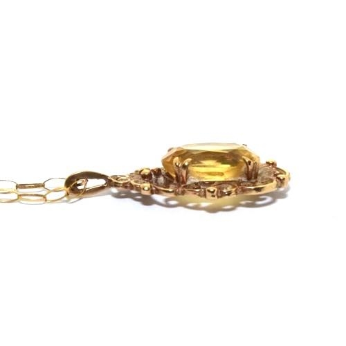 344 - 9ct gold Citrine pendant necklace in a scroll open work design on a 46cm chain