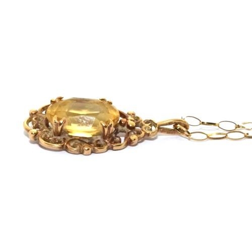 344 - 9ct gold Citrine pendant necklace in a scroll open work design on a 46cm chain