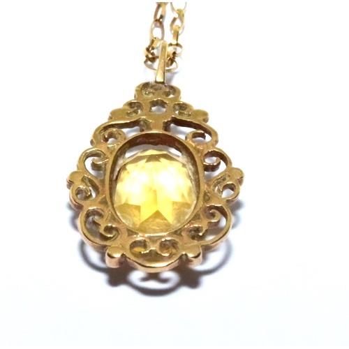 344 - 9ct gold Citrine pendant necklace in a scroll open work design on a 46cm chain