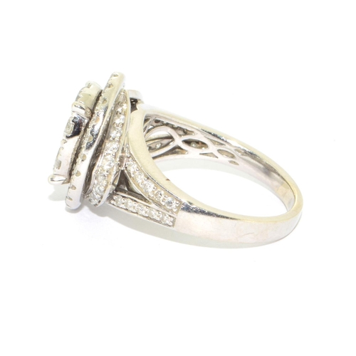 352 - 14ct white gold ladies diamond statement ring the main oval design hallowed by a ring of further dia... 