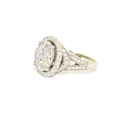 352 - 14ct white gold ladies diamond statement ring the main oval design hallowed by a ring of further dia... 