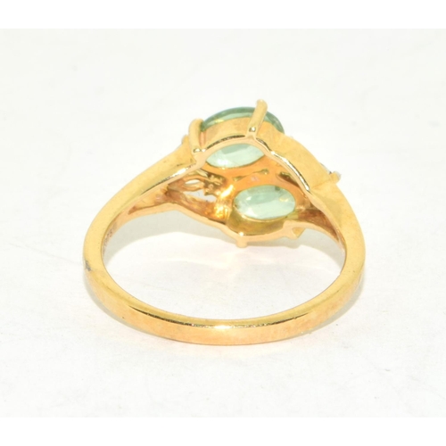 295 - 9ct gold ladies twin stone Peridot ring with clear stone decoration size N