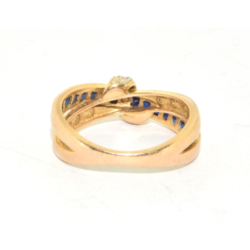 310 - 9ct gold ladies cross over Sapphire and Diamond ring hallmarked as diamond in the ring size O