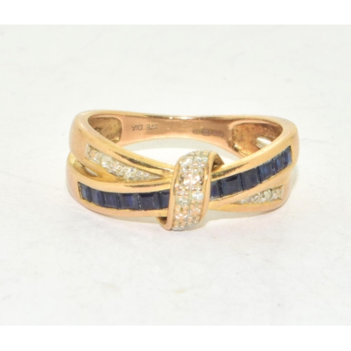 310 - 9ct gold ladies cross over Sapphire and Diamond ring hallmarked as diamond in the ring size O