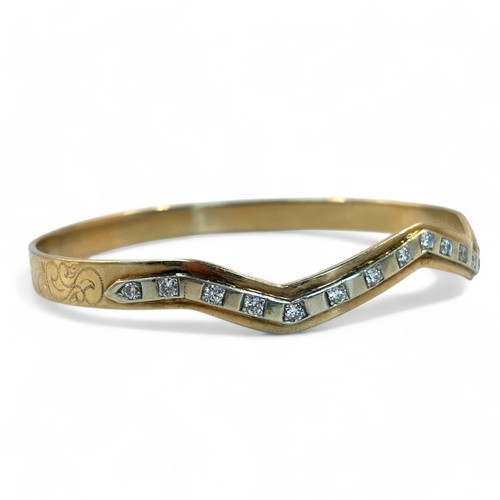 1 - A 14ct Gold & Diamond ladies bangle.Unmarked (tests as 14ct gold), set with 17 Diamonds in white... 