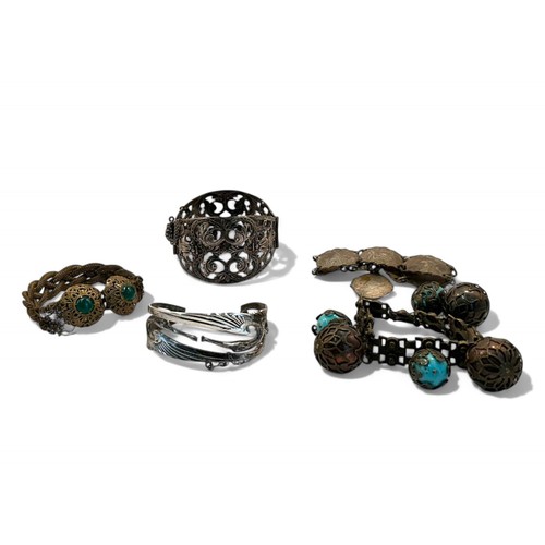 4 - A collection of five vintage bracelets. Including a French scrolled souvenir cuff bracelet, an Art N... 