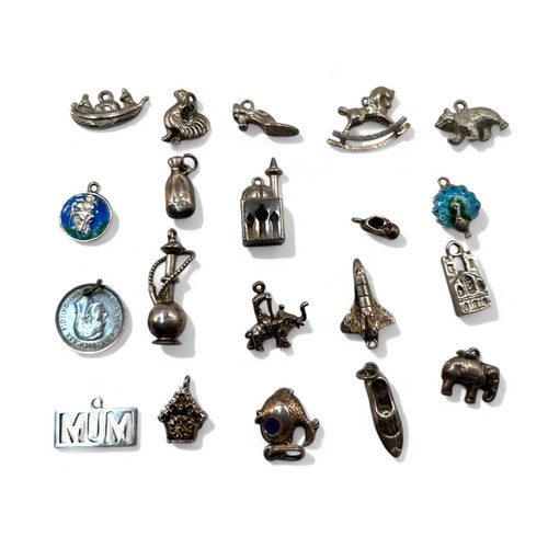 63 - A collection of 20 silver charms.