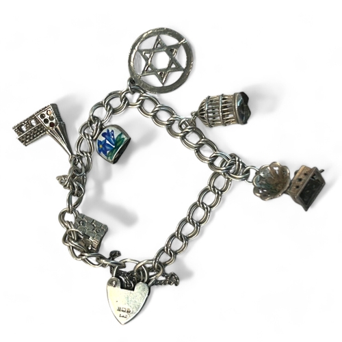 75 - A Sterling silver charm bracelet, with six miscellaneous silver charms.Weight - 23g