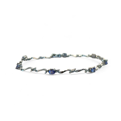 257 - A 9ct white gold, tanzanite and diamond bracelet.Set with seven beautiful oval cut Tanzanites, prong... 