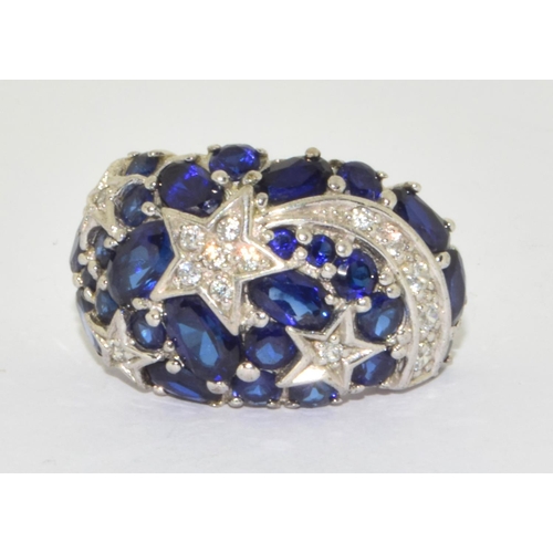 309 - 925 silver star design ring with blue stone decoration  size M