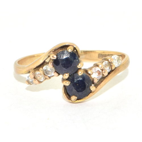 215 - 9ct gold ladies twin stone sapphire ring in a twist design with clear stone enhancement size Q