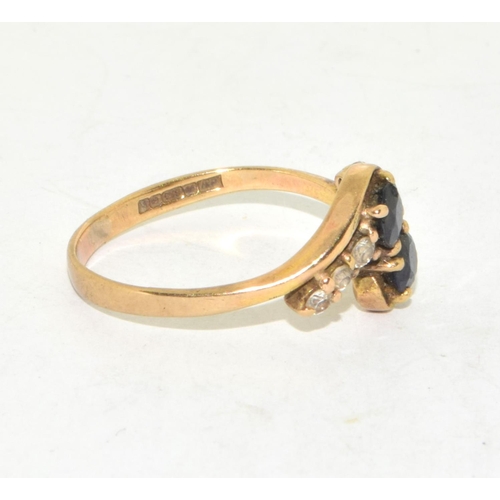 215 - 9ct gold ladies twin stone sapphire ring in a twist design with clear stone enhancement size Q