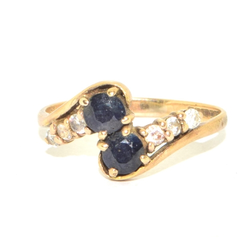 215 - 9ct gold ladies twin stone sapphire ring in a twist design with clear stone enhancement size Q