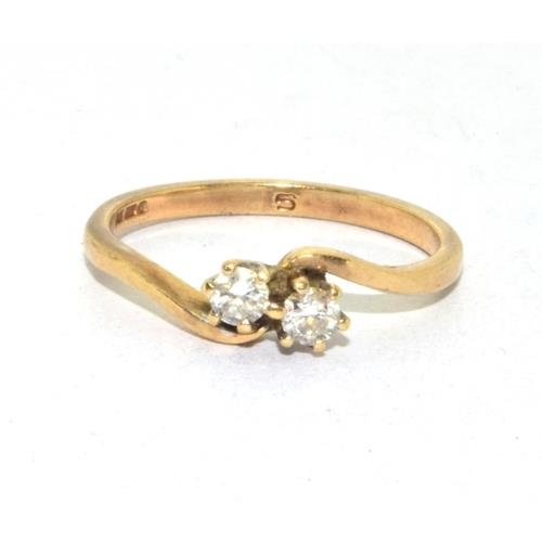 216 - 9ct gold ladies Diamond cross over  over twin stone ring approx 20pionts size O