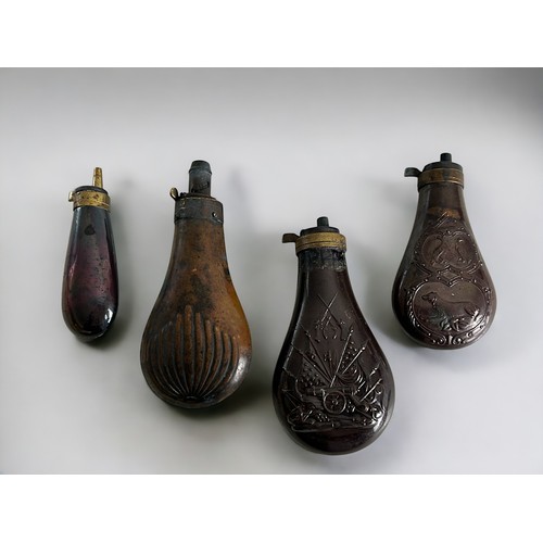 37 - A collection of four copper & brass Powder flasks. To include Colt & Philadelphia examples.