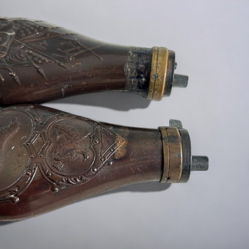 37 - A collection of four copper & brass Powder flasks. To include Colt & Philadelphia examples.