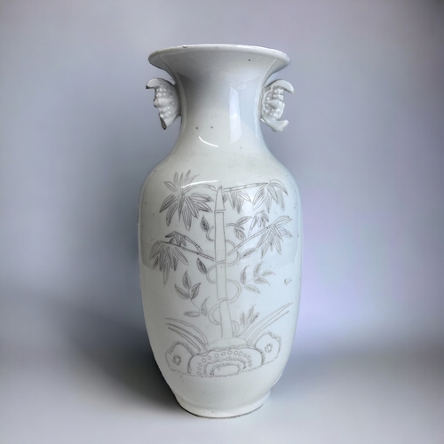 128 - A CHINESE WHITE PORCELAIN BALUSTER VASE. Late Qing / Republic period. Black painted Bamboo outcrop. ... 