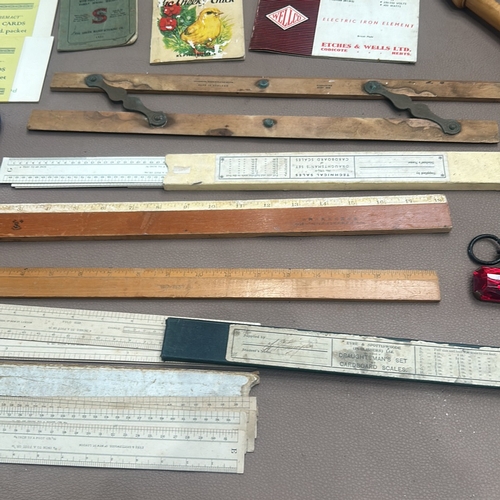 75 - Collection of vintage measuring tools and rulers, assorted printed materials, and draughtsman's card... 