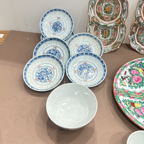 86 - Assorted Chinese porcelain dishes and bowls feature vibrant Famille Rose and blue-and-white designs.... 