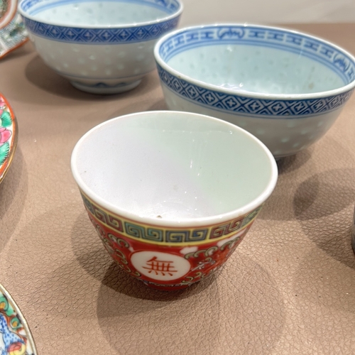 86 - Assorted Chinese porcelain dishes and bowls feature vibrant Famille Rose and blue-and-white designs.... 