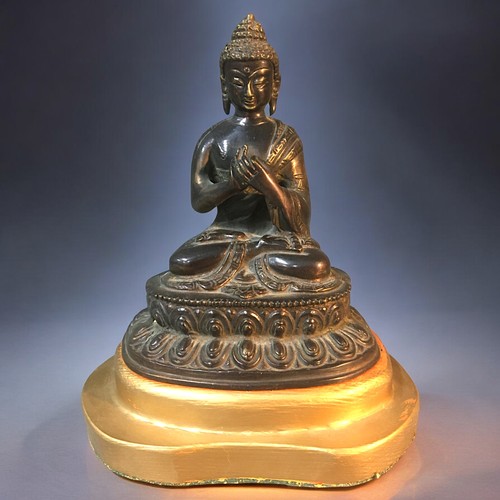 123 - A Chinese seated Bronze Buddha on later stand.Height - 18cm (not including stand).