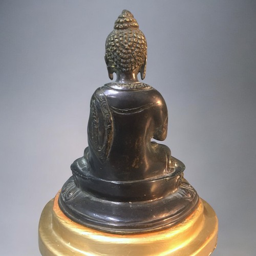 123 - A Chinese seated Bronze Buddha on later stand.Height - 18cm (not including stand).