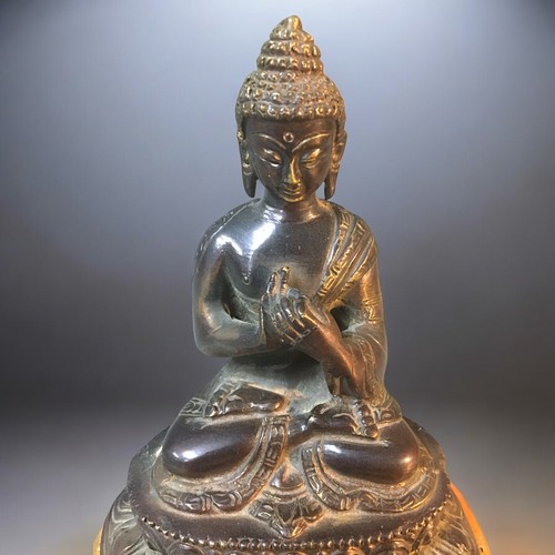 123 - A Chinese seated Bronze Buddha on later stand.Height - 18cm (not including stand).