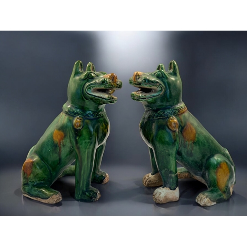 132 - A pair of Chinese Sancai glazed dogs.In the Tang style.Height - 19cm