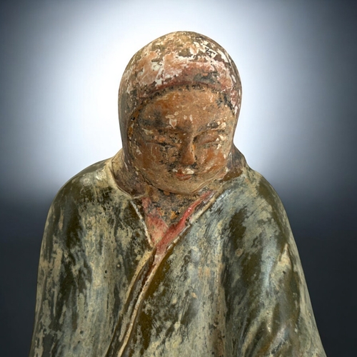 138 - A Chinese green glazed figure of a kneeling, robed woman.In the Northern dynasties style.Height - 20... 