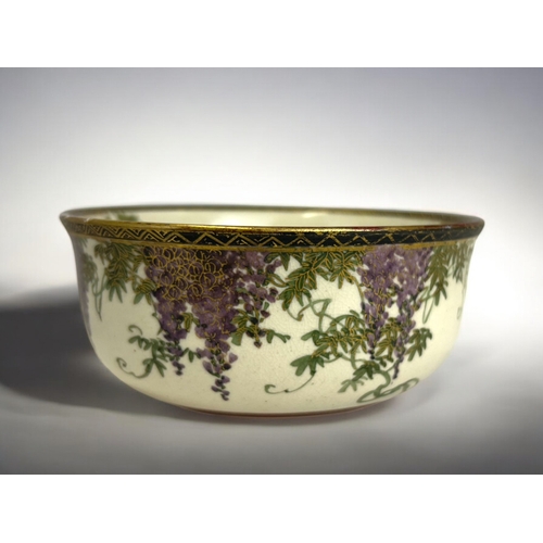 139 - A Japanese Satsuma bowl.Late Meiji period.Finely painted with trailing Wisteria to exterior. Central... 