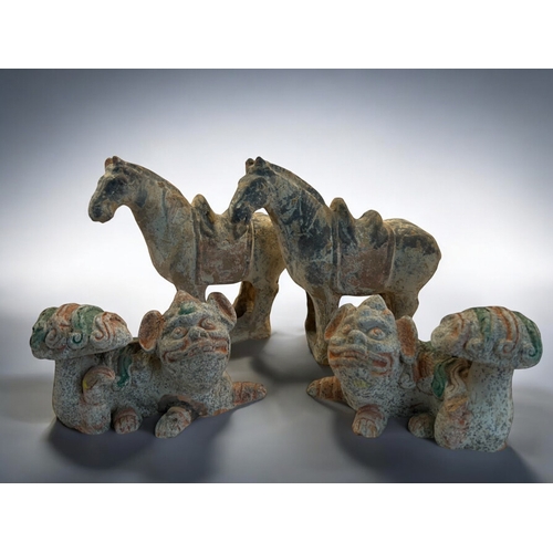 144 - A pair of Chinese Buddhistic Lions, together with a pair of funerary type horses. In the Tang style.... 