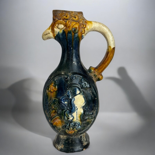 148 - A Chinese Tang style Phoenix head ewer. Sancai-blue glaze.Relief moulded 'Parthian shot archer' on h... 