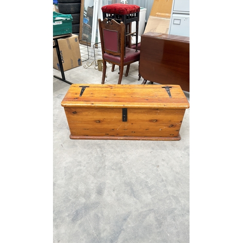 345 - Wooden storage chest with iron hinges and latch, featuring a rustic pine finish, from the mid-centur... 