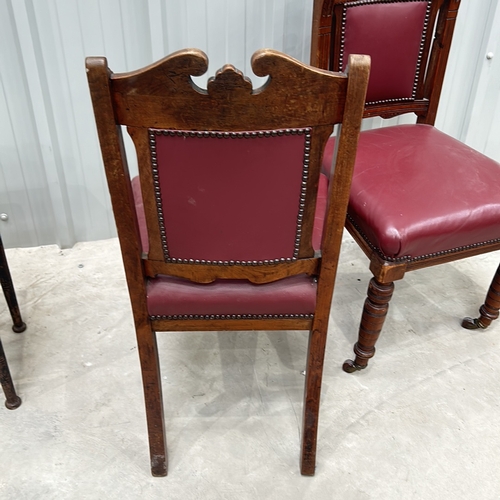 272 - Victorian-style mahogany chairs, set of two, feature red leather upholstery and decorative carving. ... 