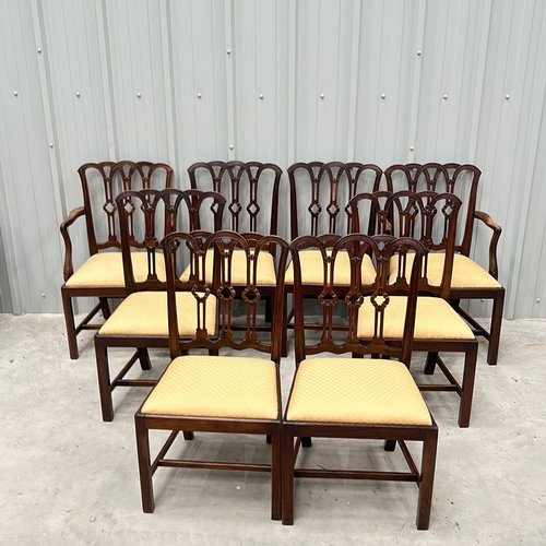 274 - Set of eight mahogany dining chairs with intricately carved backs and upholstered seats, featuring a... 