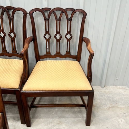 274 - Set of eight mahogany dining chairs with intricately carved backs and upholstered seats, featuring a... 