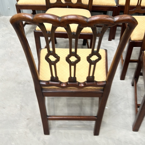 274 - Set of eight mahogany dining chairs with intricately carved backs and upholstered seats, featuring a... 