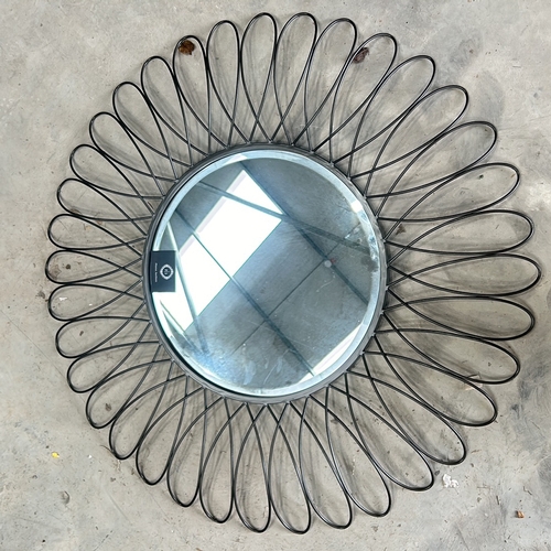 298 - Round wall mirror with a sunburst design, featuring black metal loops and a central mirrored surface... 