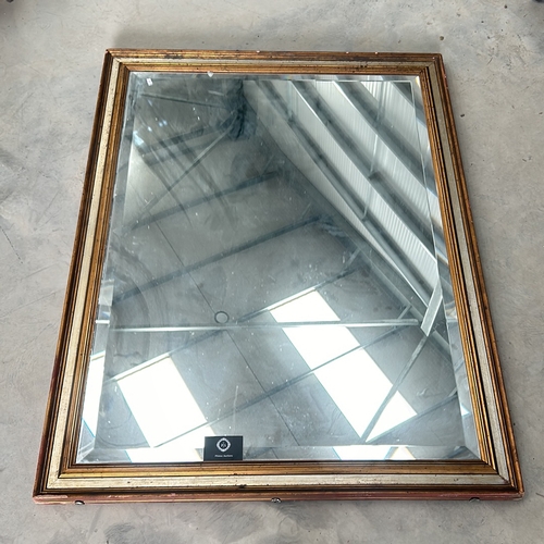 304 - Large square mirror with a gilt wooden frame and a beveled edge. The frame displays a classic design... 