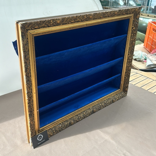 311 - Ornate gold-tone framed shadow box with deep blue velvet lining and shelves.