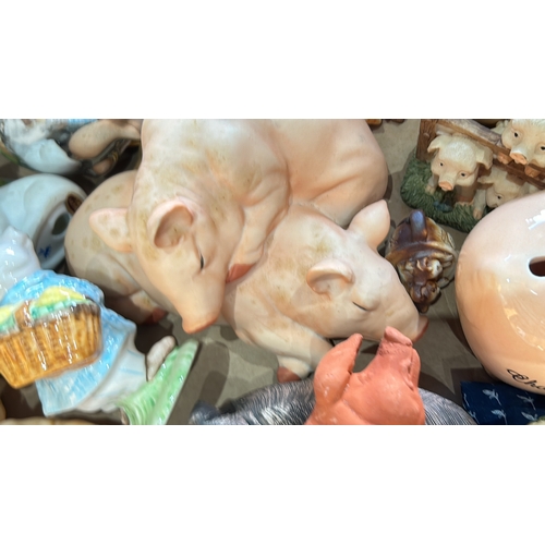 313 - A diverse assortment of pig-themed ceramic figurines, featuring various designs and styles.