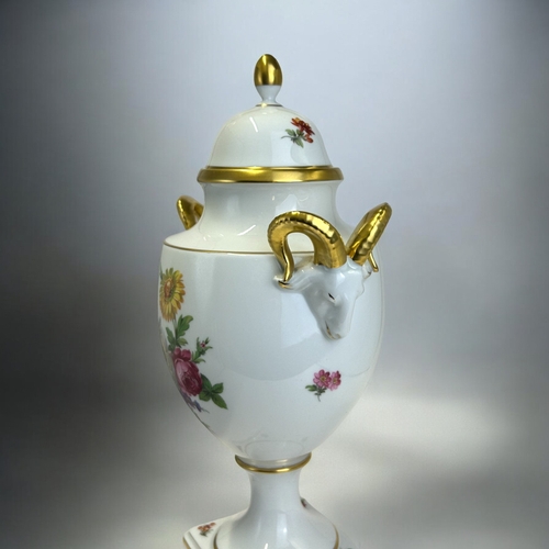 149 - A Kaiser porcelain lidded vase.Foliate sprays, with twin gilded ram handles. Height - 32cm ... 