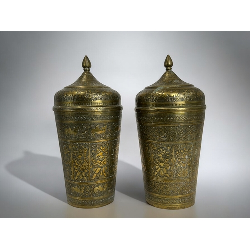 151 - A pair of Mughal lidded brass pots.19th century.Elaborately engraved animals & deities.Height - ... 