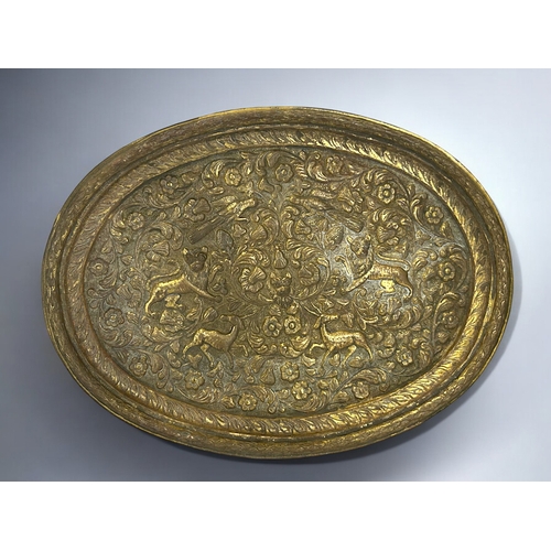 153 - A 19th century Persian gilded copper tray.Repousse decorated with animals amongst foliate design.36 ... 